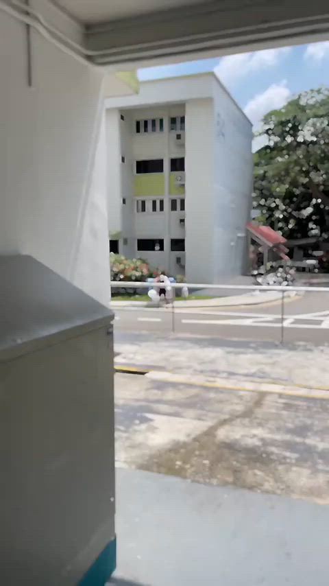 Father puts crying boy in blue recycling bin, scolds him while sibling watches on